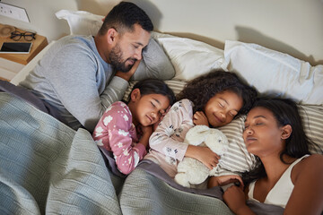 Serene multiethnic family sleeping together on double bed