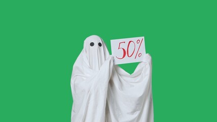 Funny halloween ghost in white sheet shows paper sign with word 50 percent discount, isolated on...
