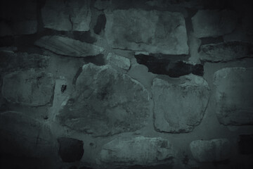 Ancient stonewall in dark monochrome as background