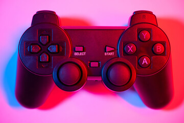 Game controller, video game joystick or gamepad control on a colorful background, close-up © Gecko Studio