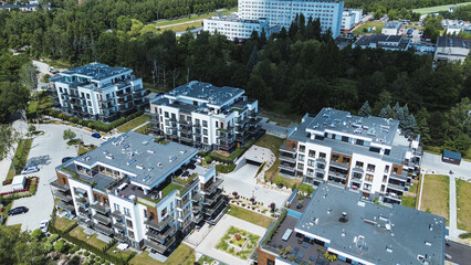 Fototapeta premium Apartment complex with landscaped gardens and modern design from above