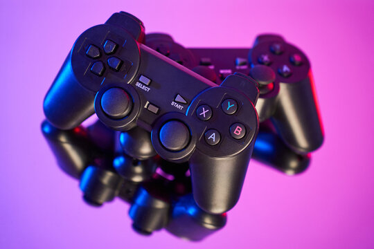 Game controller, video game joystick or gamepad control on a colorful background, close-up