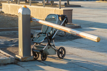 empty baby stroller near closed barrier