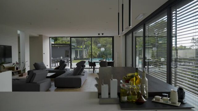 Modern interior living room with automatic window system, opening windows with the room illuminated.