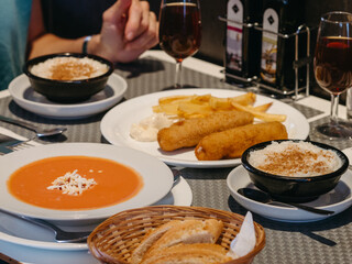 A couple eating in a restaurant with the table full of plates