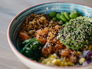 Poke bowl with salmon, avocado, and other vegetables