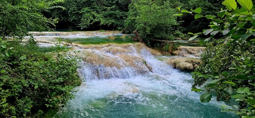 Small water cascade in the Sentierelsa Trail, Colle di Val d'Elsa, Italy. June 26, 2024. River...