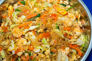 Stir fried glass noodles egg and shrimp.Add carrots, spring onions and tomatoes.