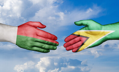 Madagascar and Guyana country handshaking with flags, consensus concept international co-operation illustration