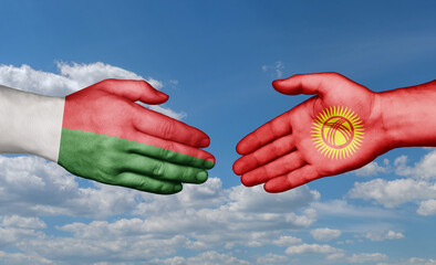 Kyrgyzstan and Madagascar country handshaking with flags, consensus concept international co-operation illustration