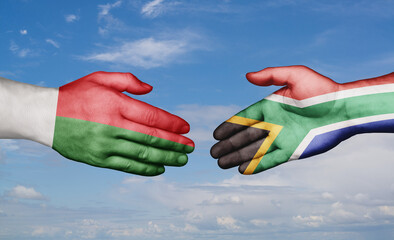 South Africa and Madagascar country handshaking with flags, consensus concept international co-operation illustration