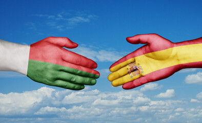 Spain and Madagascar country handshaking with flags, consensus concept international co-operation illustration