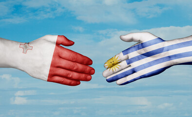 Uruguay and Malta country handshaking with flags, consensus concept international co-operation illustration