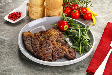 Grilled chuck roll steak with arugula