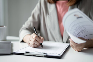 Business woman employer holding resume hiring recruit looking cv resume to hire candidates, analyzing information before job interview. Recruitment concepts