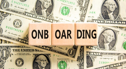 Onboarding success symbol. Concept word Onboarding on wooden blocks. Dollar bills. Beautiful background from dollar bills. Business onboarding success concept. Copy space.