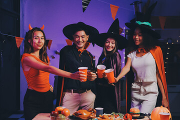 Joyful office Halloween party with coworkers in costumes, celebrating with drinks and laughter, fostering teamwork and festive spirit