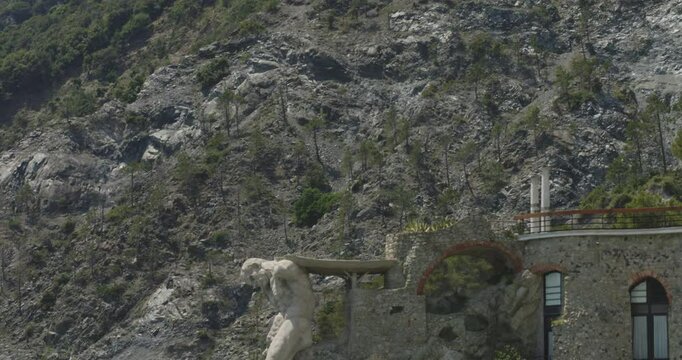 Statua del Gigante - Giant Statue Of Neptune In Italian Riviera Town Of Monterosso al Mare, Italy. tilt-down reveal