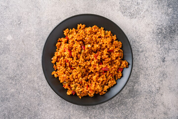  Turkish traditional food tomato bulgur pilaf on black stone table