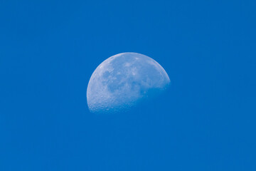Half moon in blue sky during daytime