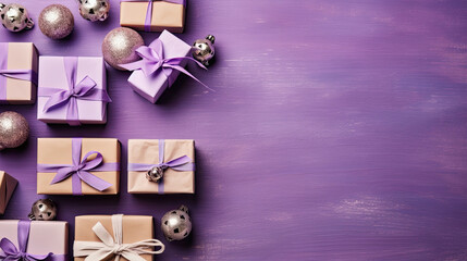 Top view of gifts, bows and Christmas decorations on a purple wooden background