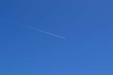Plane trail in blue sky