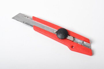 Red utility knife cutter isolated on white background. Stationery cutter knife