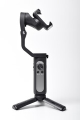 Gimbal stabilizer for Smartphone isolated on white background. Modern stabilizer-gimbal for photo-video shooting. Gadgets for blogging, streaming, video and videography
