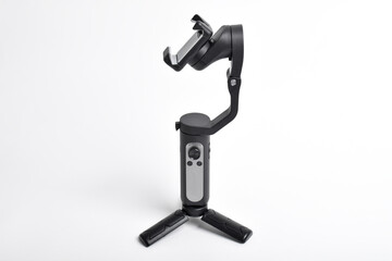 Gimbal stabilizer for Smartphone isolated on white background. Modern stabilizer-gimbal for photo-video shooting. Gadgets for blogging, streaming, video and videography
