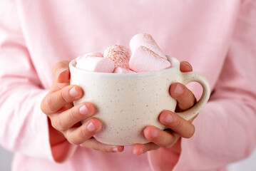 Chocolate drink with marshmallows in hands of girl. Vegan, sugar and lactose free.