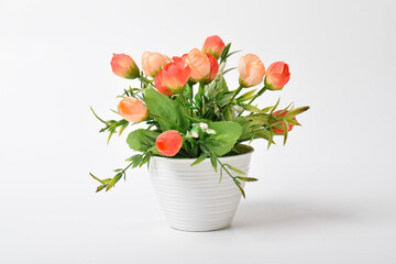 Front view of beautiful artificial tulips in pot isolated on white background.House plant