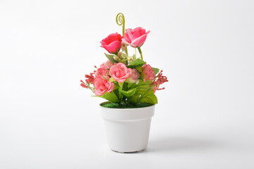 Front view of beautiful artificial pink flowers in pot isolated on white background.House plant. Home decoration