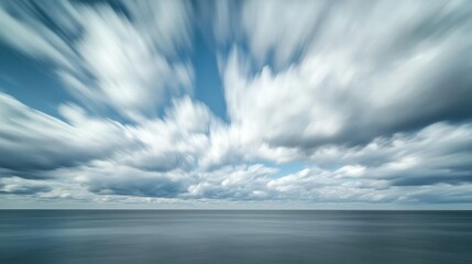 Obraz premium Blurred Clouds Over a Calm Sea Horizon
