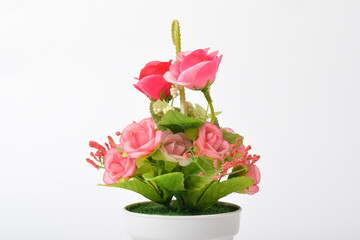 Front view of beautiful artificial pink flowers in pot isolated on white background.House plant. Home decoration