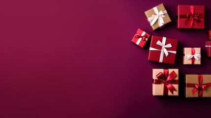 Top view of gifts, bows and Christmas decorations on a vivid maroon background