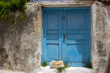 old door of stone house in Emporio town on Santorini island, Greece