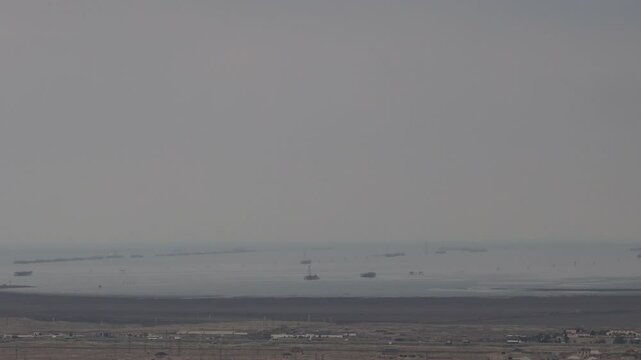 Gobustan, Azerbaijan A view of the desert and Caspian Sea on a misty day.  