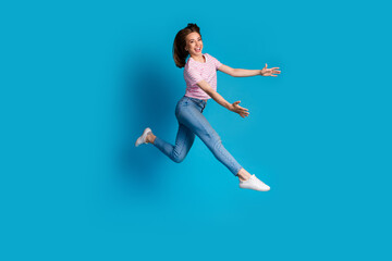 Photo of positive lovely cute woman wear trendy pink clothes hold object empty space isolated on blue color background