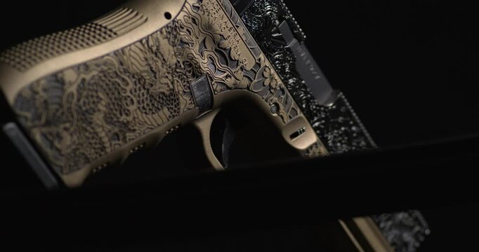 Black Knife Blade Showcased Against Burnt Bronze Coated Glock Gun with Laser Engraving. closeup shot