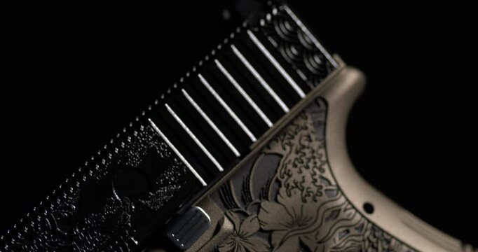 Glock Handgun With Decorative Laser Engraved Slide. Tactical Weapon. closeup, rack focus