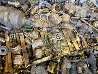 Mixed brass scrap in a junk yard heap ready to be recycled.
