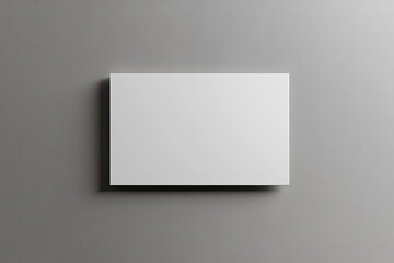 A white, blank rectangular card on the wall, against a gray background. Created with Ai