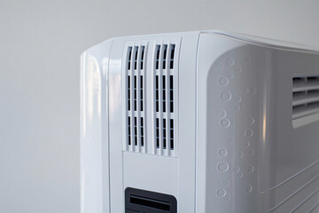Fototapeta premium Close up of a dehumidifier air outlet grille, effectively reducing air humidity and creating a comfortable indoor environment