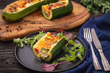Zucchini stuffed with feta cheese, egg, parsley and cherry tomatoes