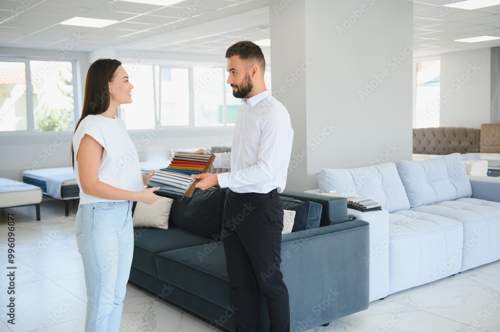 Canvas Prints salesman explaining to woman customer at furniture store