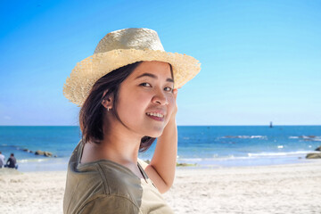 Beautiful asian woman relax on white sand beach sunny day sunglass