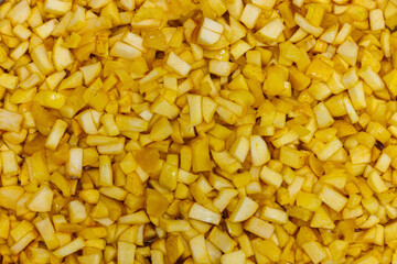 full-frame background and texture of many yellow apples sliced in order to make an apple jam