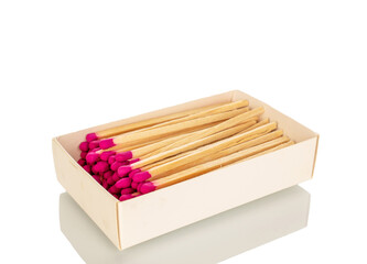 Wooden matches in a paper box for lighting a fire, macro, isolated on a white background.