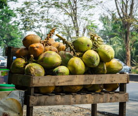 Young coconuts are sold on the side of the road, generally the seller will open and separate the water and flesh to give to the buyer.
