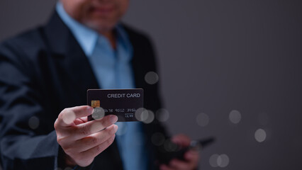 Sophisticated individual holds credit card, symbolizing financial empowerment, convenience, and digital age of transactions blurred background enhances focus on card
